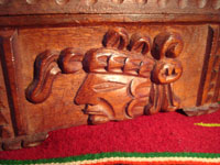 Mexican vintage wood-carving and Mexican vintage folk art, a wooden box beautifully carved with Mayan faces and designs, c. 1930-40. The top of the box bears a silver plaque with wonderful Mayan symbols or faces. Closeup of Mayan face on front of the box.