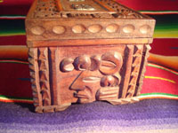 Mexican vintage wood-carving and Mexican vintage folk art, a wooden box beautifully carved with Mayan faces and designs, c. 1930-40. The top of the box bears a silver plaque with wonderful Mayan symbols or faces. Photo showing one side of the box.