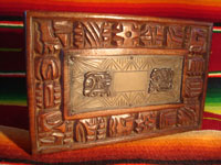 Mexican vintage wood-carving and Mexican vintage folk art, a wooden box beautifully carved with Mayan faces and designs, c. 1930-40. The top of the box bears a silver plaque with wonderful Mayan symbols or faces. Closeup of the top of the box.