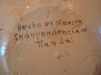 Mexican vintage pottery and ceramics, a lovely petatillo plate with graceful doves, attributed to the great potter and folk artist Balbino Lucano, Tlaquepaque, Jalisco, c. 1930's. Closeup photo of the back of the plate showing the address of Balbino Lucano's shop in Tlaquepaque, Jalisco.