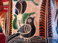 Mexican vintage pottery and ceramics. a lovely petatillo pitcher with a handle and very fine hand-painted decoration, Tlaquepaque, Jalisco, c. 1940's. Closeup photo of a bird decorating the pitcher.