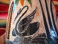 Mexican vintage pottery and ceramics. a lovely petatillo pitcher with a handle and very fine hand-painted decoration, Tlaquepaque, Jalisco, c. 1940's. Closeup photo of a swan decorating the petatillo pitcher.