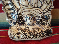 Mexican pottery and ceramics, and Mexican devotional art, a very lovely image of Our Lady of Guadalupe, done in the traditional style and colors of Tzintzuntzan, Michoacan, c. 1990's. Closeup photo of the angel at Our Lady's feet.