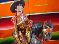 Mexican vintage folk art, and Mexican vintage pottery and ceramics, a pottery sculpture depicting a Mexican revolutionary, perhaps Emiliano Zapata or Pancho Villa, riding a beautiful horse, attributerd to the great Panduro family of sculptors, San Pedro Tlaquepaque, c. 1930's. Closeup photo of the rider's face.
