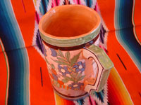 Mexican vintage pottery and ceramics, a beautiful petatillo (cross-hatching in the background, resembling a straw mat or petate, in Spanish) pottery pitcher, with beautiful and intricate decorations, Tonala or San Pedro Tlaquepaque, c. 1930's. Photo shot from above looking down at the pitcher.
