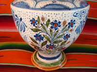 Mexican vintage pottery and ceramics, a spectacular pottery vase or urn with a cream-colored background, fantastic artwork, and covered with tiny stars, Tonala or San Pedro Tlaquepaque, c. 1920-30's.  Closeup photo of the floral designs near the base of the vase.