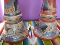 Mexican vintage pottery and ceramics, a pair of burnished pottery candleholders beautifully decorated with patterns of vines, Tonala, Jalisco, c. 1950's. Closeup photo of the animals near the base of each candleholder.