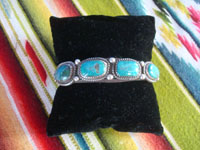 Native American Indian sterling silver jewelry, and Navajo sterling silver jewelry, a beautiful Navajo bracelet of sterling silver with four wonderful turquoise stones, with twisted wire bezzles and bump-outs, Arizona or New Mexico, c. 1960's. Main photo of the Navajo silver bracelet.