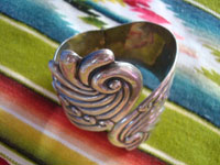 Mexican vintage sterling silver jewelry, and Taxco vintage sterling silver jewelry, a stunningly beautiful Taxco repousse clamp-style bracelet with excellent silverwork, Taxco, c. 1940's. A side view of the Taxco silver bracelet.