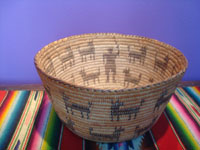 Native American Indian baskets, a beautiful Pima woven pictorial basket showing a man and 19 animals, Arizona, c. 1930's.  A photo shot from above the basket looking down at the inside.