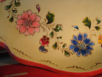 Mexican vintage wood-carving and Mexican vintage folk art, a laquer-ware tray from Olinala, c. 1940's. The tray features two old men with canes in the center, surrounded by flowers and a wonderful red rim. Another closeup photo.