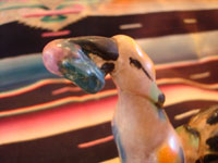 Mexican or Guatemalan vintage pottery and ceramics, a lovely pair of birds, very finely crafted and each with a round fruit in its mouth, Mexico or Guatemala, c. 1930's. Closeup photo of one of the bird's head and beak.
