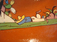 Mexican vintage pottery and ceramics, a beautiful rectangular dish with an earthen-colored (reddish) glaze background and a wonderful rural scene, Tlaquepaque, Jalisco, c. 1940's. Closeup photo of the sleeping campesino on the dish.