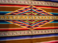 Mexican vintage textiles and sarapes, a spectacular Saltillo sarape with bands of tela deshilada (threads are removed and lovely flowers are then created with the remaining threads), c. 1920-40. This is an extremely rare and beautiful Mexican textile.  Photo of the center medallion of the sarape.