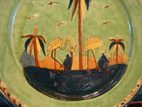Mexican vintage pottery and ceramics, a wonderful plate with a rare, pale-green background glaze and a beautiful scene with two graceful birds (egrets or cranes), Tlaquepaque, Jalisco, c. 1930's. Closeup photo of the two birds on the plate.