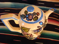 Mexican vintage pottery and ceramics, a beautiful coffee pot with a cream-colored background glaze and exquisite floral decorations, Tlaquepaque, Jalisco, c. 1940's. Photo from above the pot looking down at the lid.