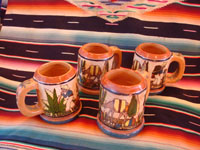 Mexican vintage pottery and ceramics, a set of four mugs with petatillo backgrounds and wonderful artwork, attributed to the famous artist, Balbino Lucano, Tlaquepaque, Jalisco, c. 1930. Main photo showing all four mugs.