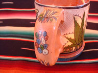 Mexican vintage pottery and ceramics, a set of four mugs with petatillo backgrounds and wonderful artwork, attributed to the famous artist, Balbino Lucano, Tlaquepaque, Jalisco, c. 1930. Photo showing the back of the handle of one mug with wonderful floral decorations.