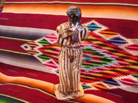 Mexican vintage folk-art, and Mexican vintage pottery and ceramics, a wonderful pottery statue of a Mexican caballero with a sarape gracefully draped over his shoulder and wearing a wonderful striped suit, attributed to the great folk-artist, Senora Pena of Tzintzuntzan, Michoacan, c. 1960's. Photo of the back of the pottery statue.