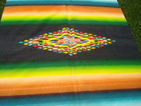 Mexican vintage textiles and Saltillo serapes (sarapes), a very beautiful Saltillo serape with a rainbow colored background and wonderful, bright colors, Saltillo, Coahuilla, c. 1940. Closeup photo of the center medallion of the serape.