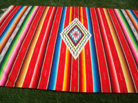 Mexican vintage textiles and Saltillo serapes (sarapes), a wonderful Saltillo serape with a red background and a beautiful center medallion, Saltillo, Coahuilla, c. 1940. A side view of the serape.