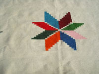 Mexican vintage textiles and serapes, a lovely textile with a valero star as the center design and a very fine weave, Texcoco, c. 1940's. Closeup photo of the valero star in he center of the textile.