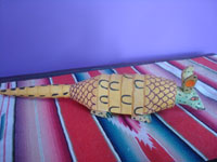 Mexican vintage folk art, a wood-carving of an armadillo, attributed to the great Manuel Jimenez, Oaxaca, c. 1950's. Side view of the carved armadillo.
