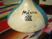 Mexican vintage folk art, a wonderful pair of pottery Day of the Dead candleholders by the famous late artist Alfonso Castillo, c. 1980. Photo of the base of one figure showing Alfonso Castilllo's signature.