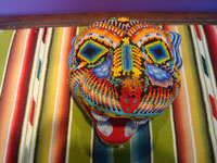 Mexican vintage folk art and beadwork, a wooden-carved mask representing a jaguar, Huichol, c. 1970's. Main photo of the Huichol mask.