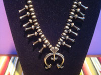 Native Amaerican vintage sterling silver jewelry, and Navajo vintage sterling silver jewelry, a beautiful squash blossom necklace, all silver with stamping on blossoms and Naja, Arizona or New Mexico, c. 1950's. Closeup photo of the naja.