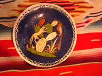 Mexican vintage pottery and ceramics, and Mexican vintage folk art, a pottery plate from Tlaquepaque, Jalisco, with a wonderful scene of a fox and beautiful bird (a quetzal), on a dark blue slip, c. 1930-40. Main photo.