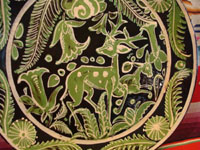 Mexican vintage pottery and ceramics, and Mexican vintage folk art, a fantasia pottery plate from Tlaquepaque, Jalisco, c. 1930-40. The artwork on the plate features two lovely deer, one with great horns, amidst flowers and foliage. Closeup of the center of the plate.
