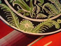 Mexican vintage pottery and ceramics, and Mexican vintage folk art, a fantasia pottery plate from Tlaquepaque, Jalisco, c. 1930-40. The artwork on the plate features two lovely deer, one with great horns, amidst flowers and foliage. Photo showing one edge of the plate.