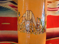 Mexican vintage pottery and ceramics, and Mexican vintage folk art, a pottery bottle from Tlaquepaque, Jalisco, c. 1930. The bottle has a lovely cream-colored background, with a wonderful scene of a snoozing Mexican campesino with his burro amidst wonderful trees and cacti. The artwork on this piece is exceptionally fine. A closeup photo of the burro.