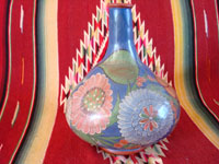 Mexican vintage pottery and ceramics, a wonderful burnished jar from Tonala, c. 1930's. The burnished jar is decorated with beautiful flowers, and has a wonderful blue background. Main photo of the jar.