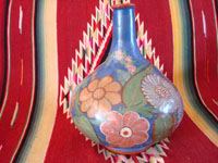 Mexican vintage pottery and ceramics, a wonderful burnished jar from Tonala, c. 1930's. The burnished jar is decorated with beautiful flowers, and has a wonderful blue background. Photo showing another side of the jar.