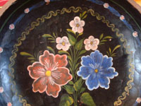 Mexican vintage wood-carving, and Mexican vintage folk-art, a beautiful carved and hand-painted batea from Quiroga, Michoacan, c. 1930's. Closeup photo of the front of the batea, showing the lovely painted flowers.