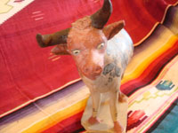 Mexican vintage pottery and ceramics, and vintage Mexican folk art, a wonderful burnished pottery bank in the form of a wonderful bull, with very detailed artwork on both sides, Tonala or Tlaquepaque, c. 1930's. A photo showing the face of the burnished pottery bull from Tonala or Tlaquepaque.