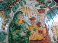 Mexican vintage pottery and ceramics, a lovely talavera bowl decorated with the image of the Baby Christ, along with his Mother, Mary, and St. Anne, the mother of Mary, Guanajuato, c. 1950's.  A closeup photo of the figures at the center of the bowl.
