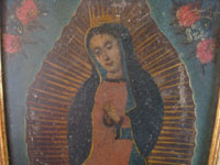 Mexican vintage devotional art, and Mexican vintage tinwork art, a beautiful retable depicting Our Lady of Guadalupe, painted on tin and framed, c. 1930. Closeup photo of Our Lady's face.