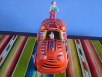 Mexican vintage folk art, a wonderful taxi with a happy passenger, attributed to the great Candelario Medrano, Santa Cruz de las Huertas, Jalisco, c. 1950's. View of the front of the taxi.