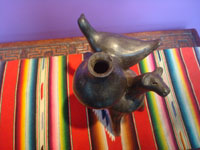 Mexican vintage folk art, a pottery cow with a bird and large water jar on its back, attributed to the great Heron Martinez, Acatlan, Puebla, c. 1950's. A side view of the cow.