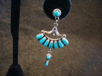 Native American Indian sterling silver jewelry, and Navajo vintage sterling silver jewelry, a stunning pair of Navajo dangling earrings, silver with beautiful turquoise (perhaps Blue Gem), Arizona or New Mexico, c. 1970's. Closeup photo of one earring.