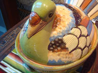 Mexican vintage pottery and ceramics, a lidded pottery casserole in the form of a nesting turkey, Tonala or San Pedro Tlaquepaque, Jalisco, c. 1940's. Closeup photo of the front of thee casserole showing the turkey's face.