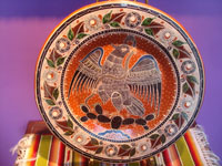 Mexican vintage pottery and ceramics, a very beautiful pottery charger with incredibly fine artwork featuring the Mexican eagle, Tonala or San Pedro Tlaquepaque, c. 1950's. Main photo of the charger.