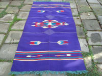 Vintage New Mexican textiles, a lovely woolen textile from the weaving center of Chimayo, New Mexico, c. 1930's. The weaving has a beautiful and very rare purple background, with colorful Chimayo-style design elements in various wonderful colors. Main photo of the textile.