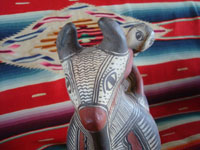 Mexican vintage folk art, and Mexican vintage pottery and ceramics, a wonderful pottery figure of a powerful bull with one happy rider, Guerrero, c. 1940's. Photo focusing on the bull's face.