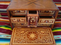 Mexican vintage folk art, and Mexican vintage woodcarvings and masks, a fabulous wooden escritorio (portable writing desk) with very fine marquetry inlay work, Oaxaca, c. 19th century. Another photo of the inside of the desk, with the cover open and showing some open drawers.