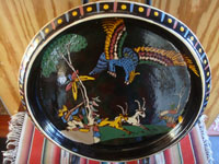 Mexican vintage pottery and ceramics, a beautiful blackware charger with a wonderful scene of a hunter aiming his rifle at a fierce eagle, as gazelles wander by, Tonala or San Pedro Tlaquepaque, c. 1940's. Main photo of the charger.