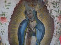 Mexican vintage devotional art, and Mexican vintage folk art and tinwork art, a beautiful retablo depicting Our Lady of Guadalupe, painted on tin, c. 1930.  Closeup photo of Our Lady's face.